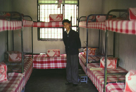 Red and white checkered bunk beds of a Chengdu youth reformatory where convicts sleep 14 per cell. China.