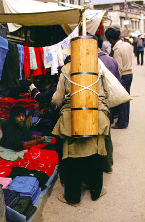 Yak butter churn being carried on the back of a villager in Tibet. China.