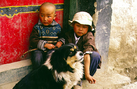 Children and a dog on the streets of Lhasa, Tibet. China.