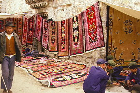 Lavishly designed carpets for sale by street vendors in Lhasa, Tibet. China.