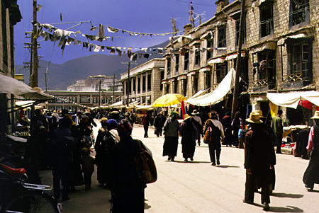 Street life in the center of Lhasa, Tibet where prayer flags span the streets. China.