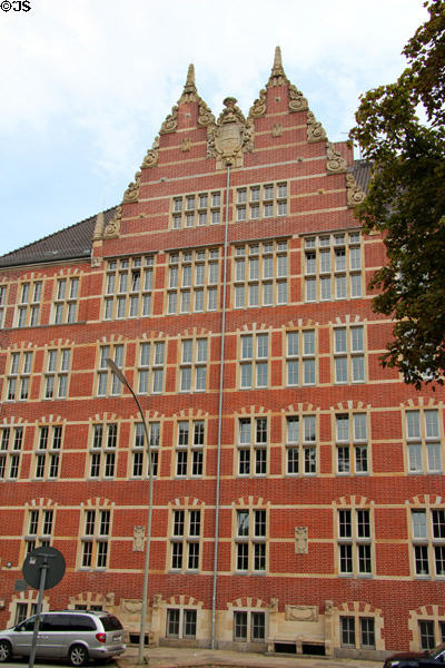 Ornate roofline of Hanseatic brickwork style university building (1905) on Holstenwall. Hamburg, Germany.