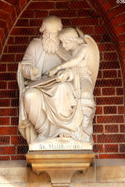 Statue of Evangelist, St Matthew, with his attribute angel at entrance to St Peter's Church. Hamburg, Germany.