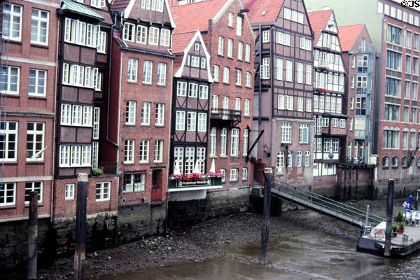 Typical Hanseactic brick buildings lining Hamburg canal at low tide. Hamburg, Germany.