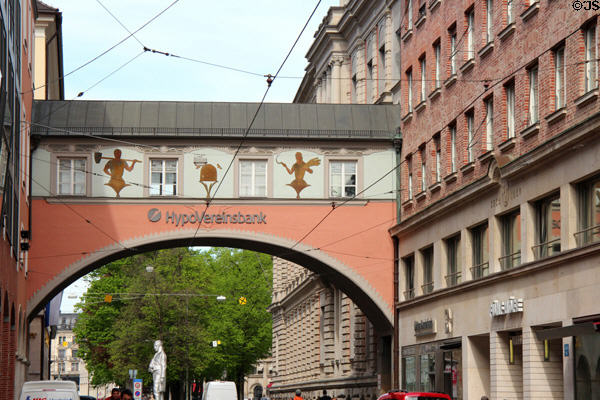 Arched bridge over Maffeistraße between two commercial buildings. Munich, Germany.