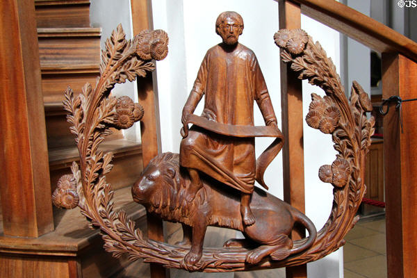 Modern pulpit carving of Evangelist St Mark with lion symbol at Heilig-Geist-Kirche. Munich, Germany.