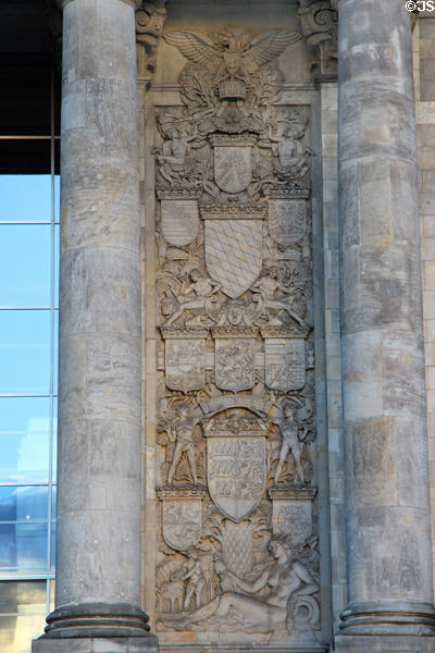 Heraldic reliefs beside doors of German Bundestag. Berlin, Germany.