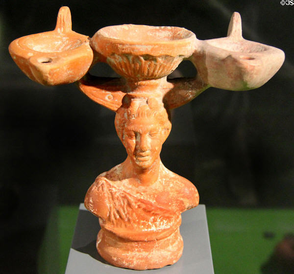 Clay oil lamps on stand shaped like woman (c1stC) at Pergamon Museum. Berlin, Germany.