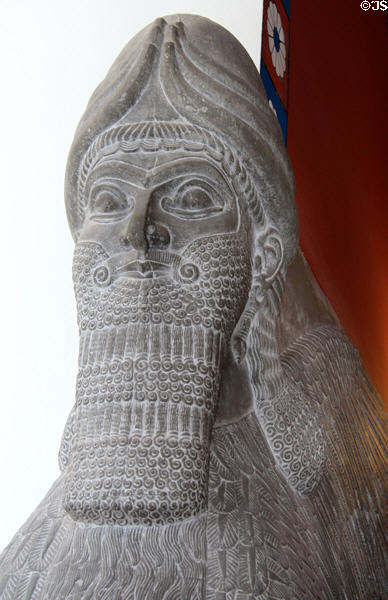 Detail of face of Assyrian schedu lamassu, a human headed, winged lion with horned crown cast from British Museum at Pergamon Museum. Berlin, Germany.