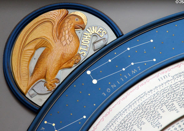 Eagle symbol of Evangelist St John on saints day calendar clock at St Mary's Church. Lübeck, Germany.