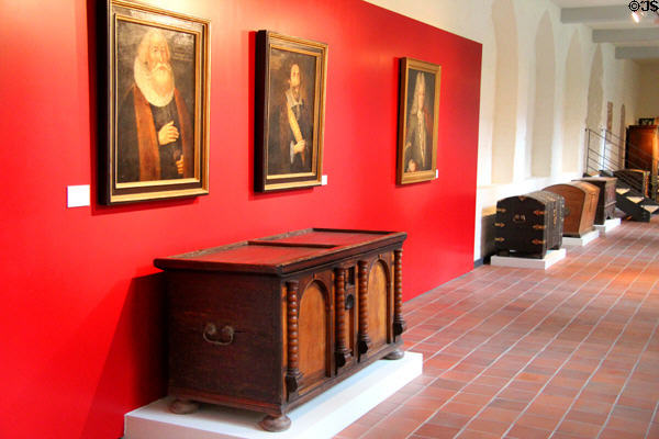 Historic portraits over Germanic chests at Cultural History Museum. Rostock, Germany.