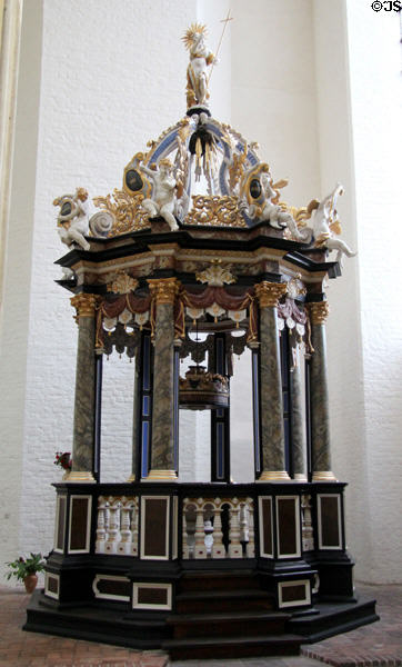 Baptismal font under canopy in Marienkirche (St. Mary's church). Stralsund, Germany.