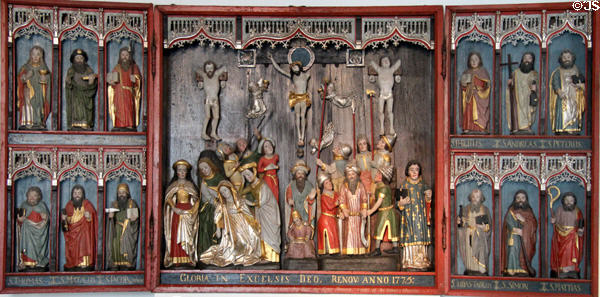 Carved wooden altar (c1460) with Crucifixion scene flanked by Apostles at Schleswig Holstein State Museum. Schleswig, Germany.