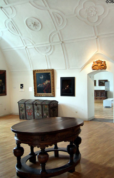 Vaulted plaster embossed room (17thC) with table, chest & paintings of the era at Schleswig Holstein State Museum. Schleswig, Germany.