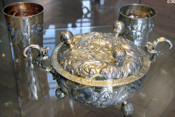 Embossed silver bowl on 3-ball feet with scroll handles & with footed lid (17thC) from Northern Germany at Schleswig Holstein State Museum. Schleswig, Germany.