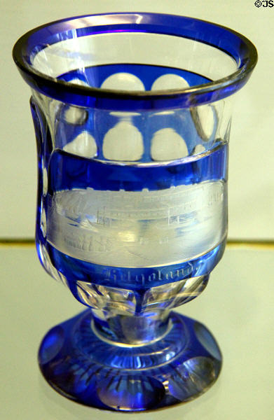 Stemmed two-colored goblet (19thC) where blue glass is cut away & etched to form picture of Helgoland at Schleswig Holstein State Museum. Schleswig, Germany.