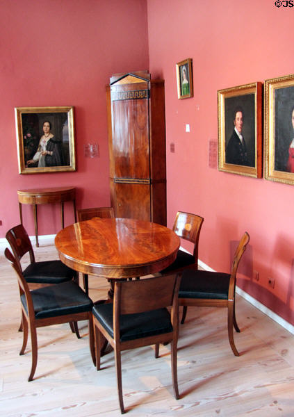Biedermeier dining table & chairs (c1820) with portraits at Schleswig Holstein State Museum. Schleswig, Germany.