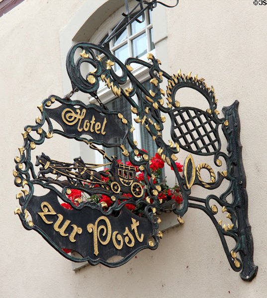 Wrought iron sign with stage coach & horse team on Post Hotel. Bacharach, Germany.