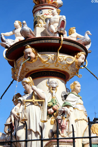 St Peter's Fountain detail with statues representing cardinal virtues of justice & courage under geese & putti riding dolphins in Hauptmarkt. Trier, Germany.