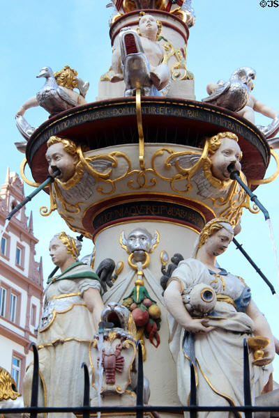 St Peter's Fountain detail with statues representing cardinal virtues of courage & temperance under geese & putti riding dolphins in Hauptmarkt. Trier, Germany.