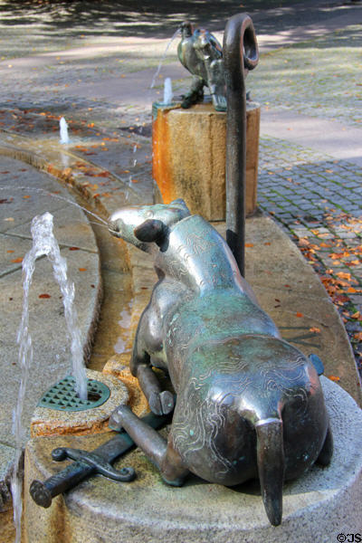 Lamb lying on sword marking the hour in Water Clock Fountain beside Red Tower. Trier, Germany.