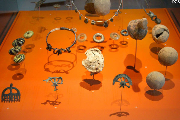 Grave goods including pendants & rings (2nd & 1stC BCE) at Trier Archaeological Museum. Trier, Germany.