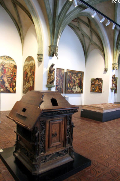 Medieval lectern with paintings beyond at Bavarian National Museum. Munich, Germany.