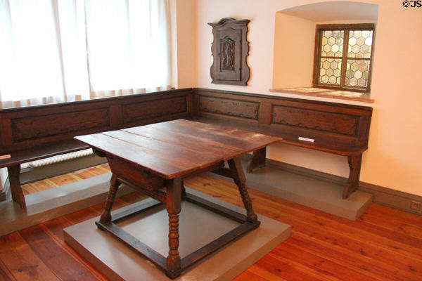 Bavarian farmer's sitting room (Stube) with corner bench & square table with stretchers (late 18thC) at Bavarian National Museum. Munich, Germany.