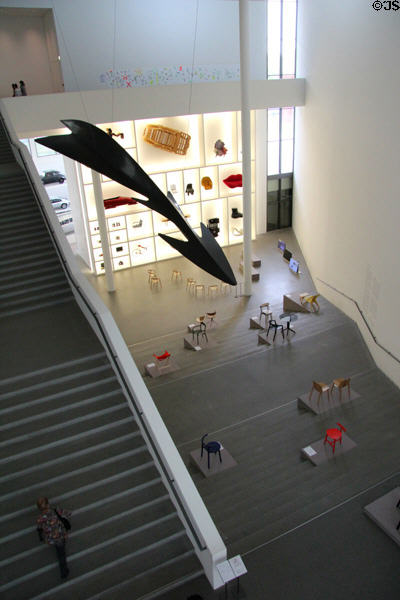 Atrium with giant arrow & chair displays at Pinakothek der Moderne. Munich, Germany.