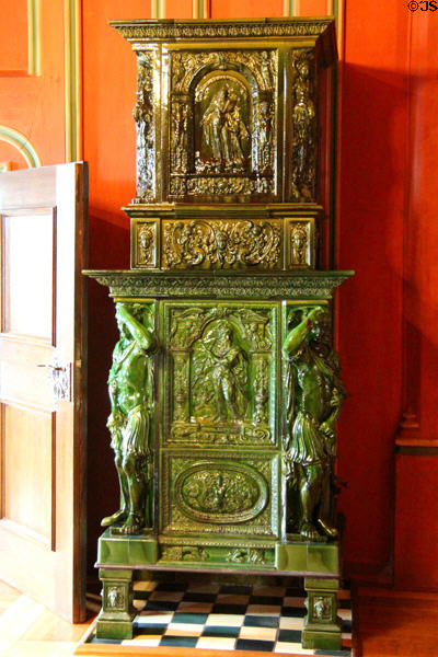 Ceramic stove in guests living room (late 19thC) shows scenes of Evangelists above & Hercules below at Coburg Castle. Coburg, Germany.