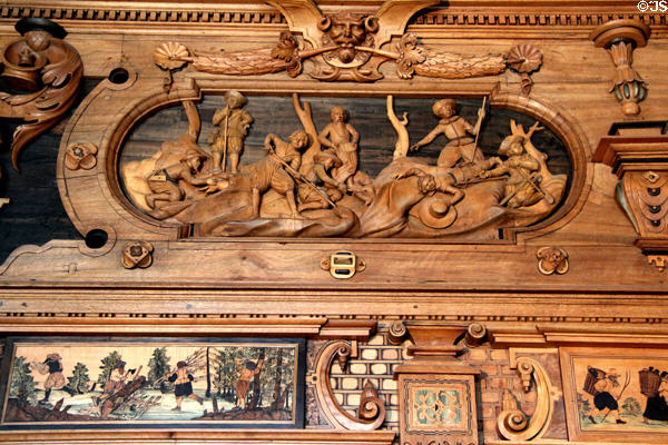 Using dachshund to hunt badger scene carving in Intarsia Hunting Room at Coburg Castle. Coburg, Germany.