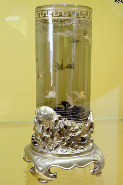 Glass vase with engraved birds on metal stand with sculpted fish (c1880) by Baccarat of France at Coburg Castle. Coburg, Germany.