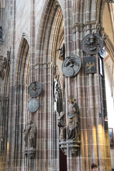 Carved holy figures on columns in St Lawrence Church. Nuremberg, Germany.