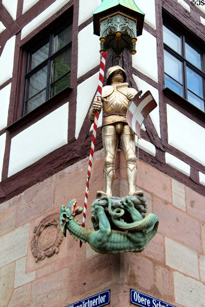 Sculpture of St Michael slaying dragon on corner of building on Tiergärtnertorplatz. Nuremberg, Germany.