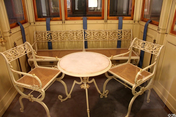 Wicker chairs & bench on terrace rail car (1865) on private train of King Ludwig II of Bavaria at Nuremberg Transport Museum. Nuremberg, Germany.