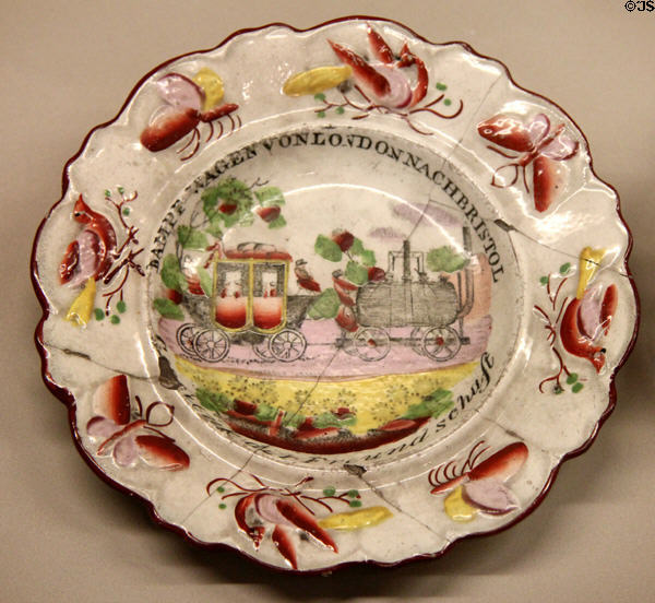 Ceramic promotional plate (c1830) made in England written in German with image of steam engine pulling coach on London-Bristol line at Nuremberg Transport Museum. Nuremberg, Germany.
