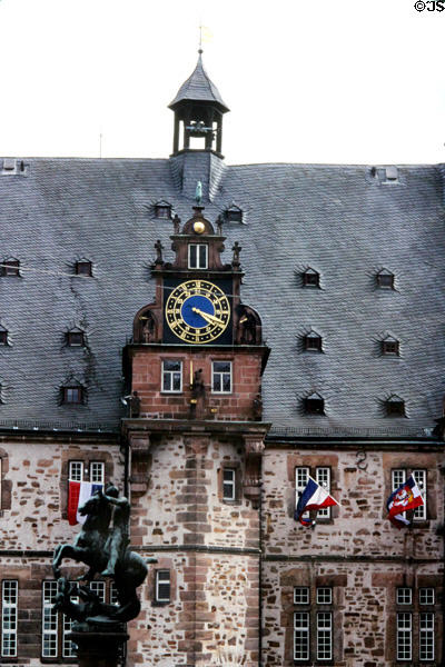Steep roof & clock tower on Rathaus (city hall) with statue of St. George vanquishing the dragon (1951) by Rudolf Breidenbach. Marburg, Germany.