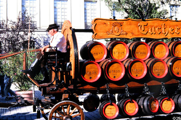 Traditional horse & wagon carrying wooden barrels of Tucher beer in town pageant. Ansbach, Germany.