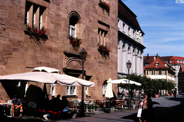 Stadthaus in old town with locals enjoying the sunshine. Ansbach, Germany.
