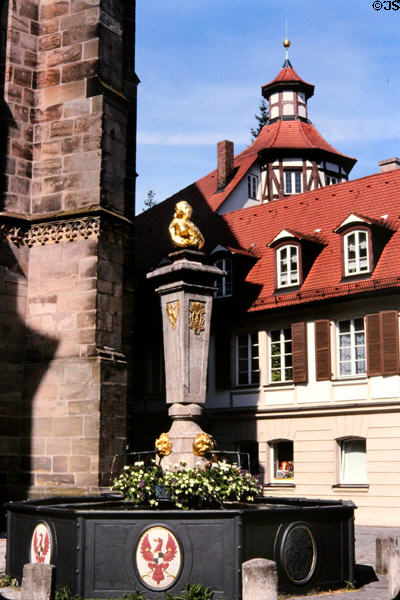 Margrave Carl fountain (1746) with Hohenzollern coat of arms on Johann Sebastian Bach Plaza in old town. Ansbach, Germany.