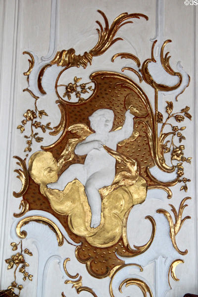 Baroque detail of cherub sitting on cloud holding moon in Goldener Saal at Academy for teacher training. Dillingen, Germany.