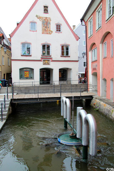 Traditional building (1579) straddles canal beyond modern sculpted canal device. Memmingen, Germany.