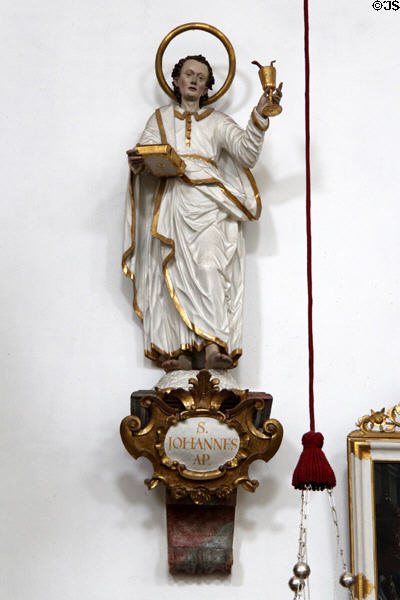 Statue of St John, Apostle, with serpent in a cup representing his power to drink from a poisoned cup without harm at St Aegidius parish church. Gmund am Tegernsee, Germany.