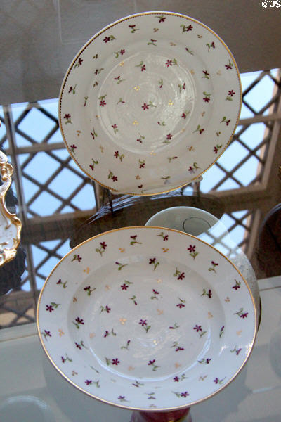 Soup plates with scattered flower design and gold rims (mid 19thC), made in Paris at Lindau Municipal Museum. Lindau im Bodensee, Germany.