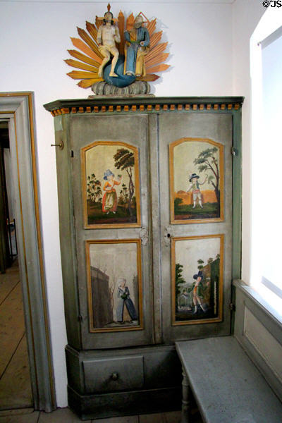 Wooden cabinet (19thC) painted with figures in local dress at Oberammergau Museum. Oberammergau, Germany.