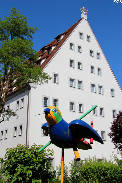 Colorful sparrow sculpture carrying a long straw, named "Pipe Sparrow", emblem of City of Ulm, outside Museum of Bread and Art. Ulm, Germany.