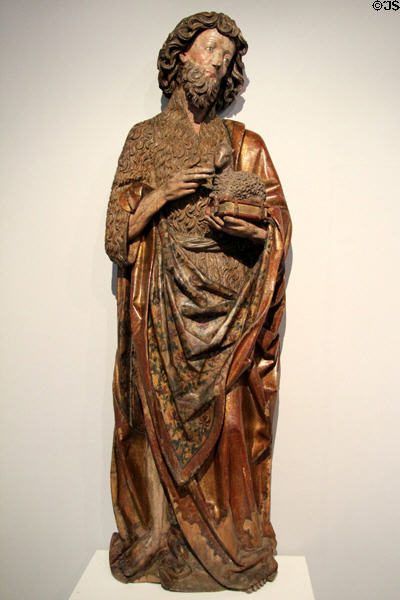 St John the Evangelist carving (c1500) carrying his lamb symbol by unknown artist at Ulmer Museum. Ulm, Germany.