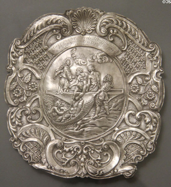 Silver plate embossed with scene of Christ directing disciples where to cast net (1738) engraved with names of local fishermen at Ulmer Museum. Ulm, Germany.