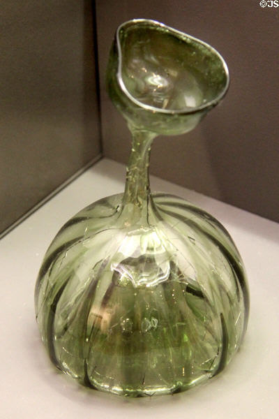 Narrow-necked green glass bottle (14th-17thC) found in Ulm at Ulmer Museum. Ulm, Germany.