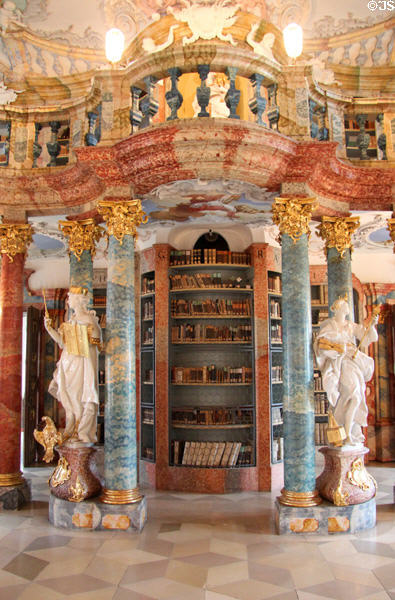 Book shelves & statues depicting academic & religious virtues in library at Kloster Wiblingen. Ulm, Germany.
